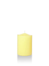 Load image into Gallery viewer, Four inch tall pale yellow coloured pillar candle shown for sale on a white background.
