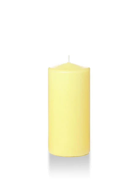 Six inch tall pale yellow coloured pillar candle shown for sale on a white background.