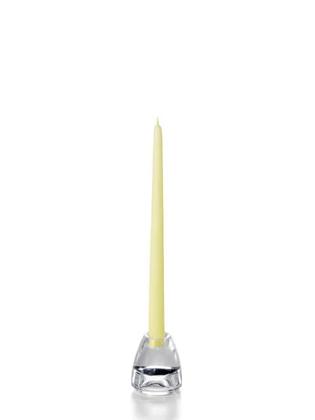 Twelve inch pale yellow coloured tapper candle for sale shown on a white background on a clear candle holder. 