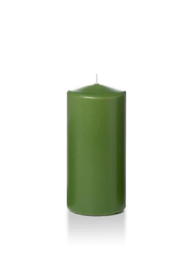 Green six inch pillar candle shown for sale on a white background.