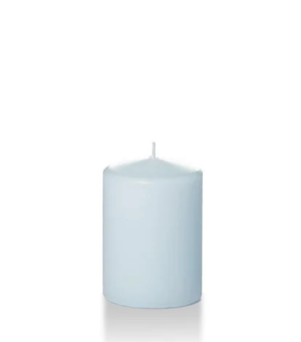 Pale blue four inch tall pillar candle shown for sale on a white background.