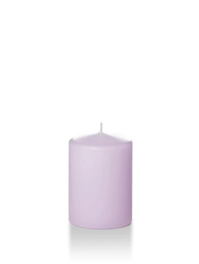 Lilac coloured four inch tall pillar candle shown for sale on a white background.
