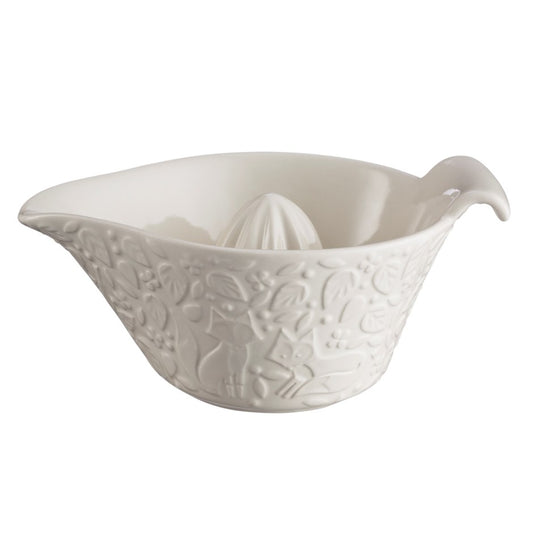 Photo of a Lemon Juicer/ Juicer stone. Made of white glazed ceramic. Forest detail surrounds the juicer with leaves trees and a pair of foxes.