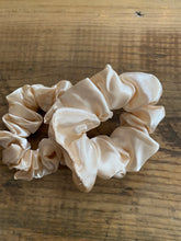 Load image into Gallery viewer, Cream coloured satin scrunchy hair tie.
