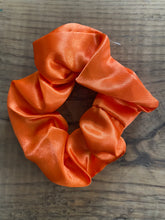 Load image into Gallery viewer, Bright orange satin scrunchy hair tie.
